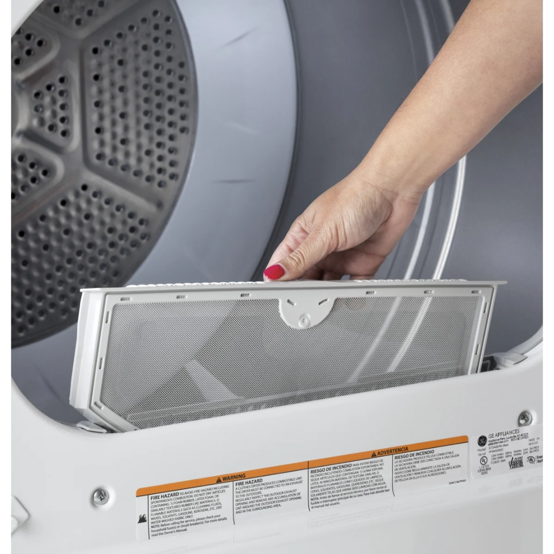 Person removing a dryer filter from a dryer