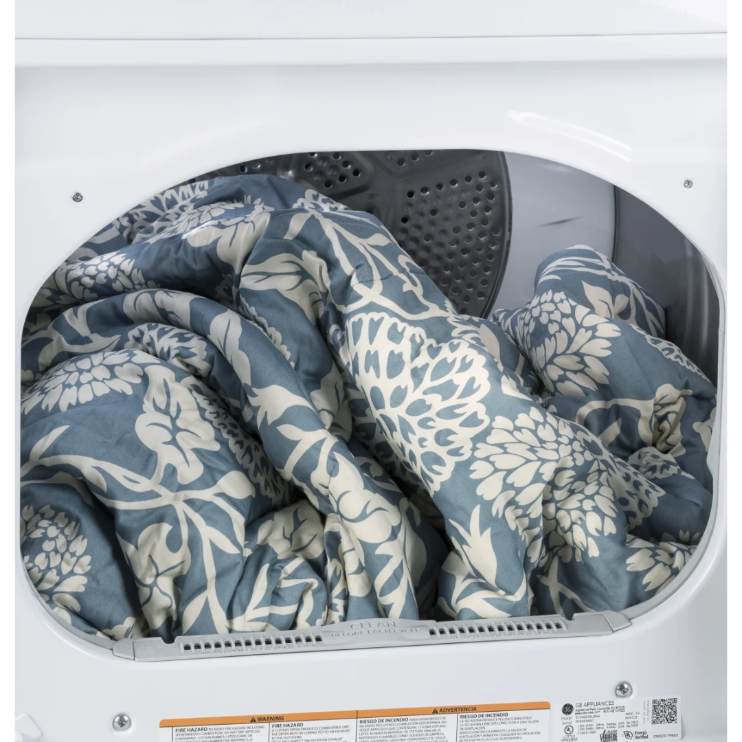 Blue and white floral comforter inside a dryer