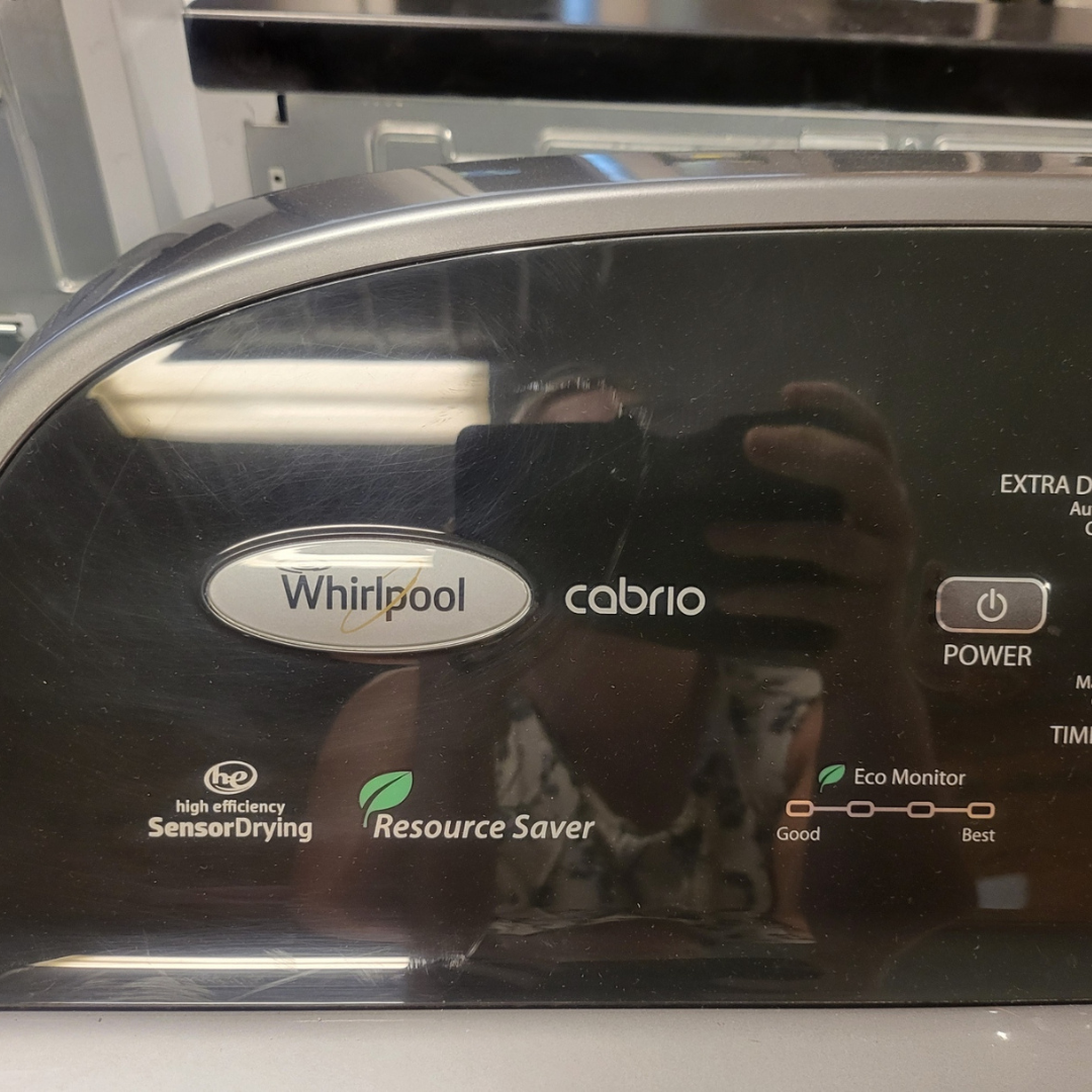 Whirlpool dryer with reflection of a person taking a photo
