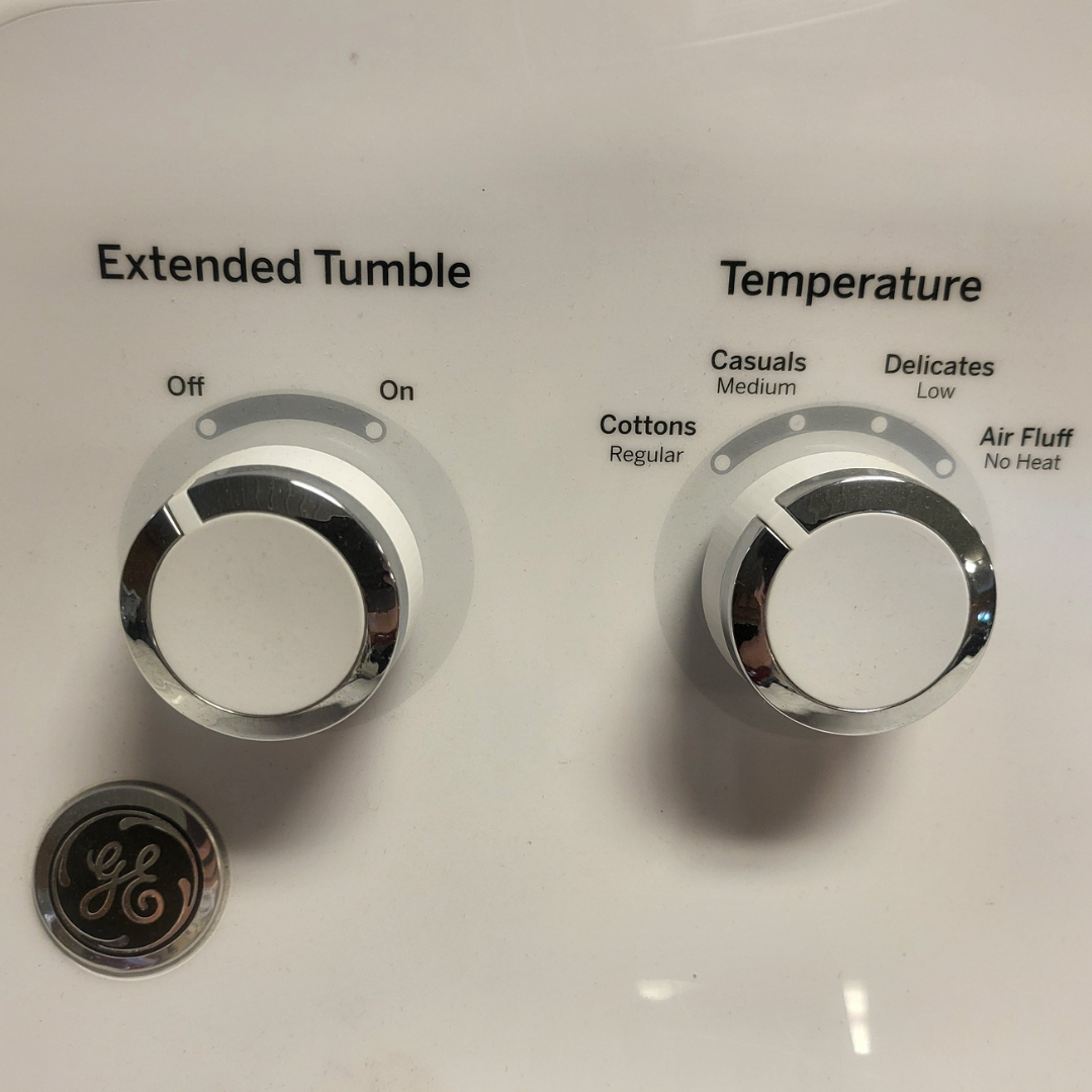Control panel with 'Extended Tumble' and 'Temperature' settings on a white background.