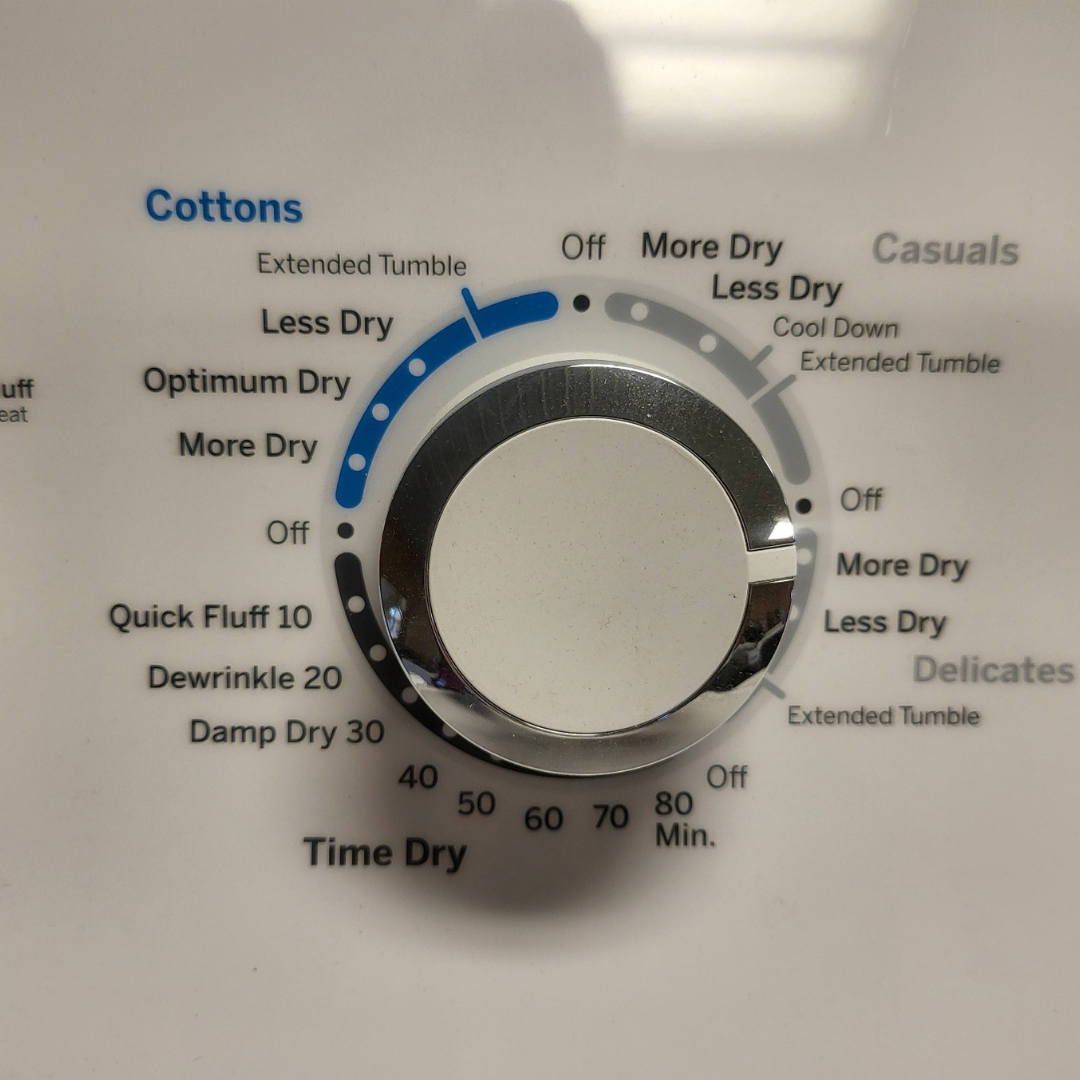 Dial on a dryer with settings for different fabric types and dry times.